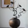 Rustic vase with artistic dried branches.