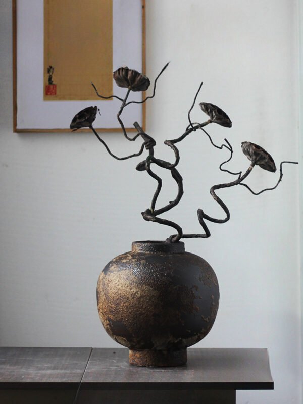 Rustic vase with artistic dried branches.