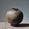 Rustic clay vase on wooden table