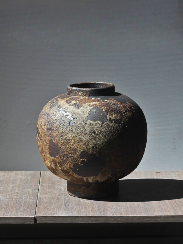 Rustic clay vase on wooden table