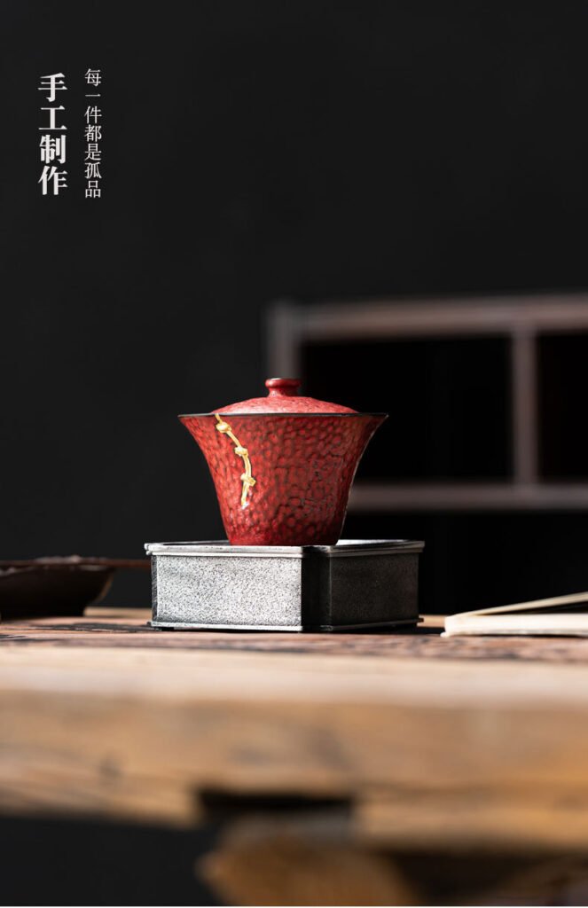 Red ceramic cup with decorative crack design.