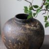 Rustic ceramic vase with green branch