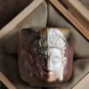 Ceramic mug with dual-faced design in wooden box.