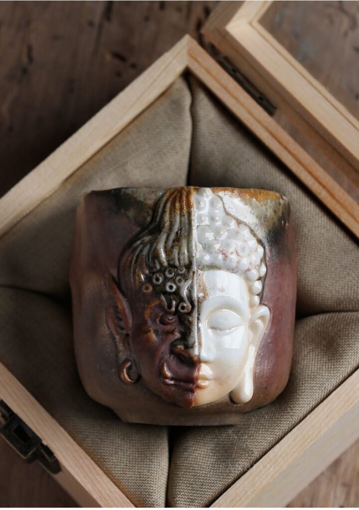 Ceramic mug with dual-faced design in wooden box.