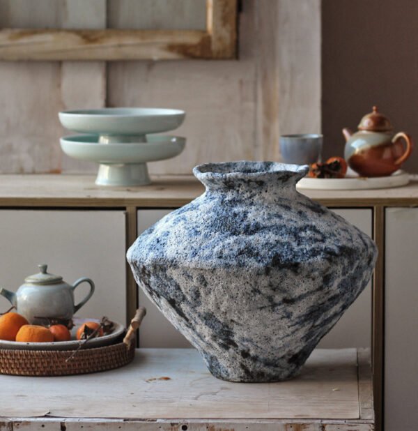 Rustic ceramic vase on wooden table