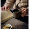 Person reading with coffee and cookies.