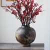 Rustic vase with red berries arrangement