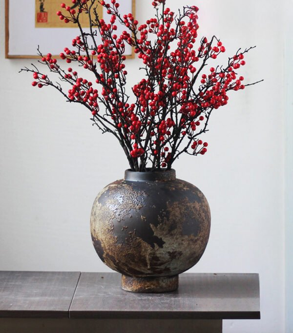 Rustic vase with red berries arrangement