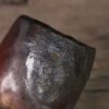 Rustic pottery cup with textured surface close-up
