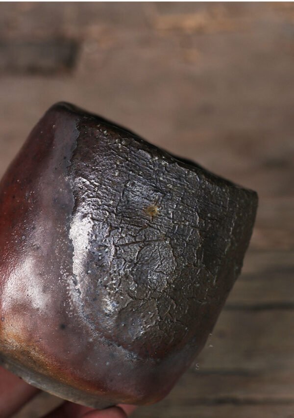 Rustic pottery cup with textured surface close-up