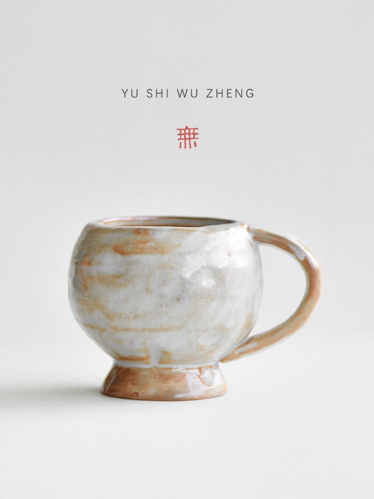 Ceramic cup with Asian text above.