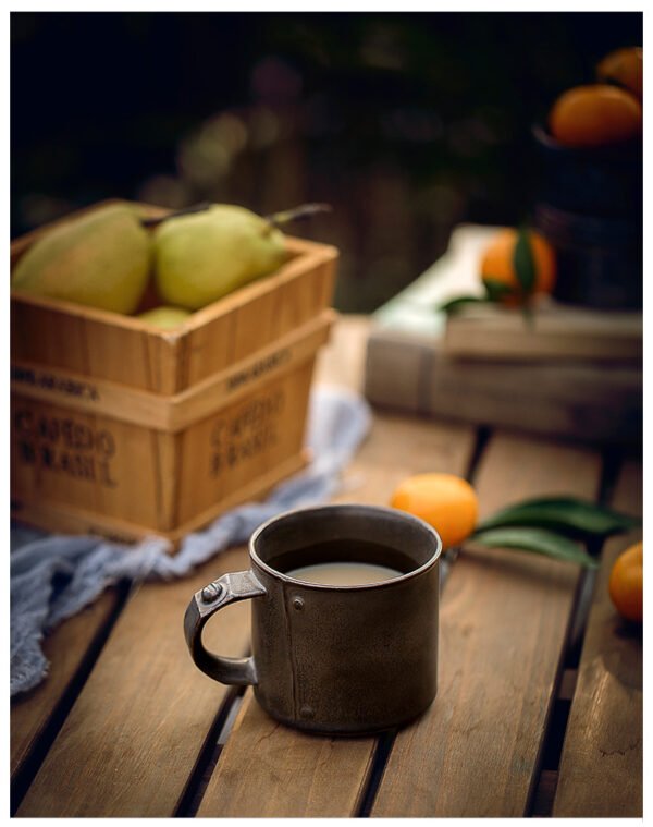 Cozy table setting with fruit and metal mug