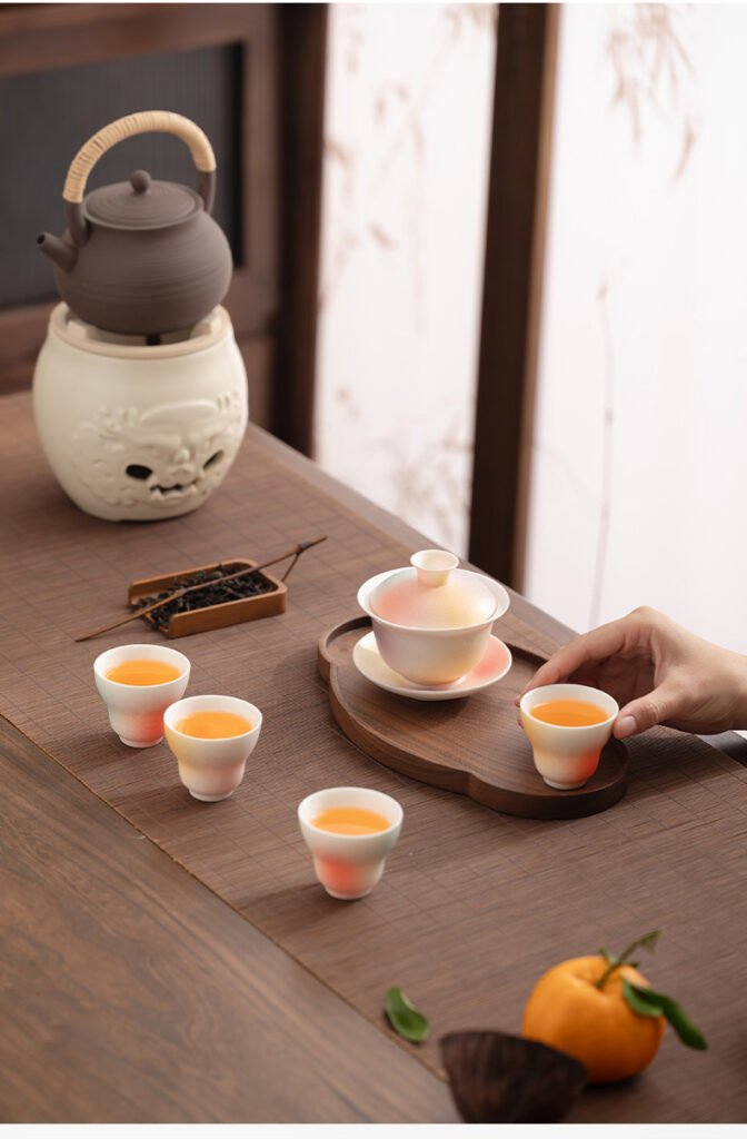 Traditional tea set with teapot and cups on table.